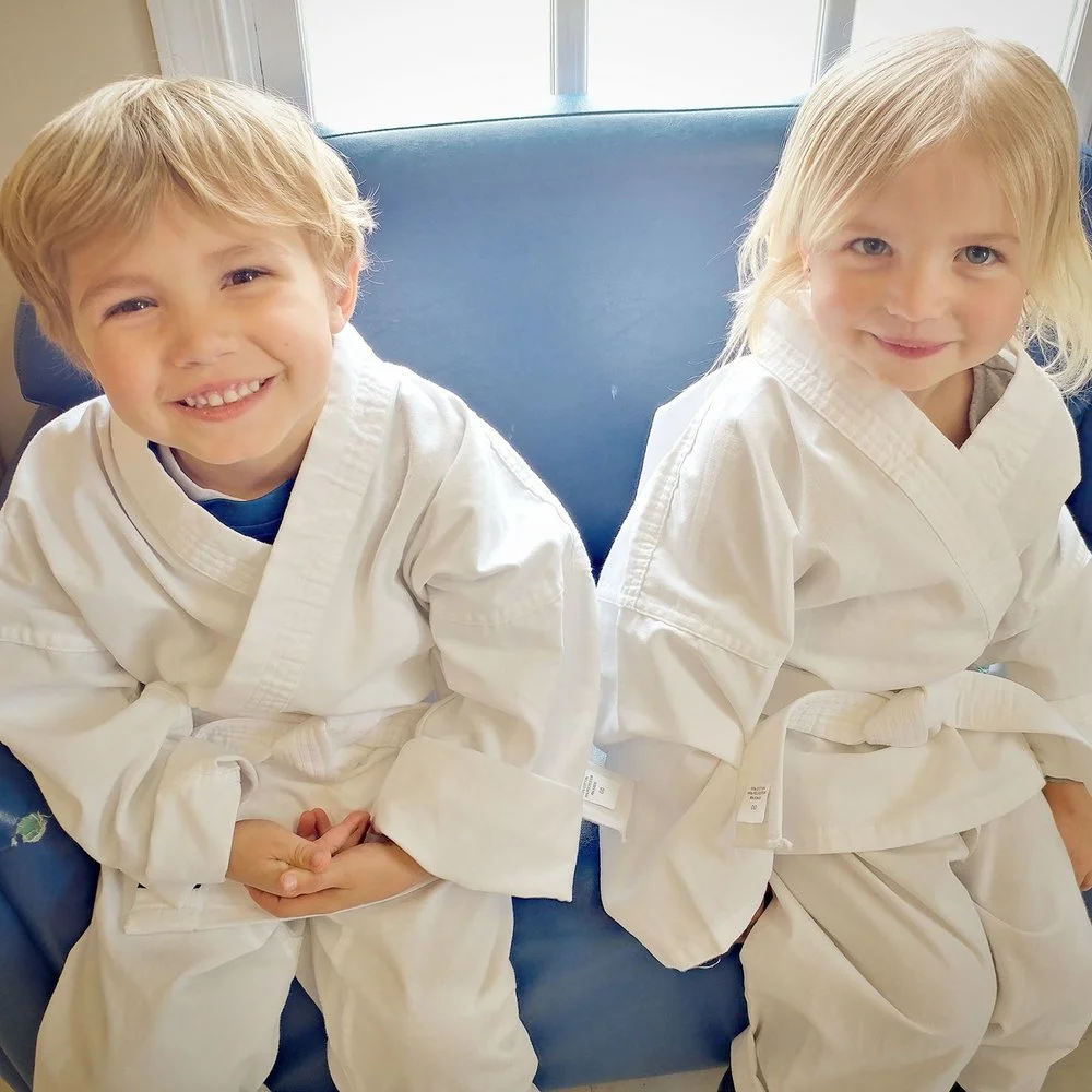 Preschool students in karate uniforms